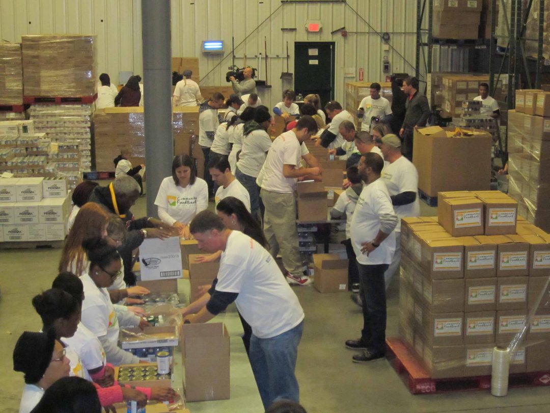 Volunteers packing boxes of food at a food bank