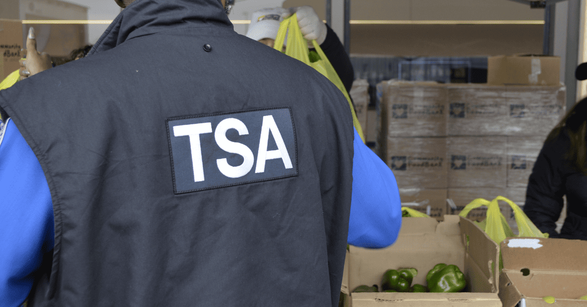 TSA agent collecting food at a distribution from CFBNJ