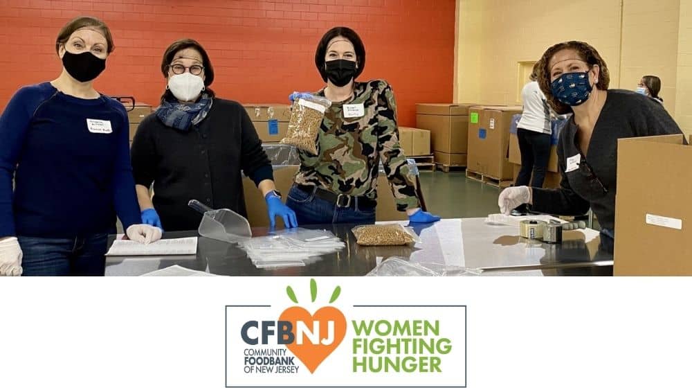 Four women packing up food with Women Fighting Hunger logo underneath