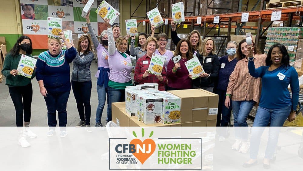 Women posing with boxes of cereal in the CFBNJ warehouse