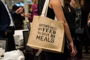 Tote bag that says "empowered by FEED to give 10 meals"