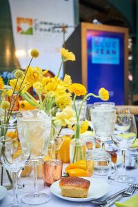 Table setting featuring yellow flowers and a blue background
