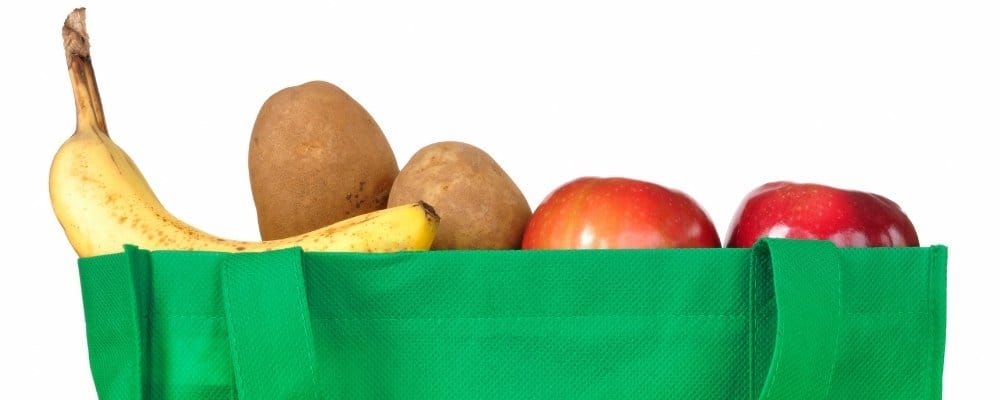 Fruit and vegetables in a green reusable shopping bag