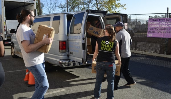 Volunteers loading boxes into a van