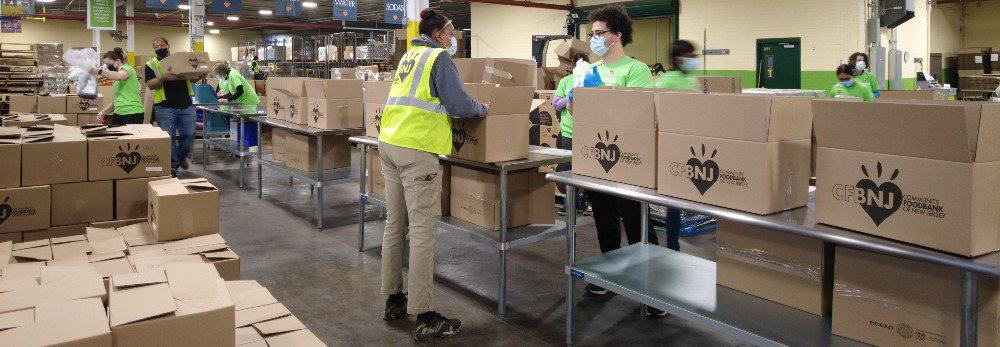 Volunteers packing boxes in the Community FoodBank of New Jersey warehouse