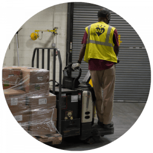 Man in warehouse pulling boxes